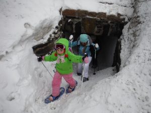 Snowhoeing mother and daughter